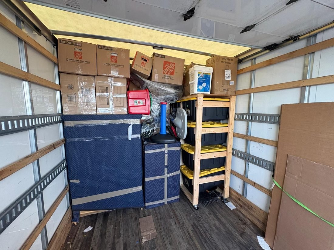 Furniture blanket-wrapped and loaded tight inside a Hermes truck