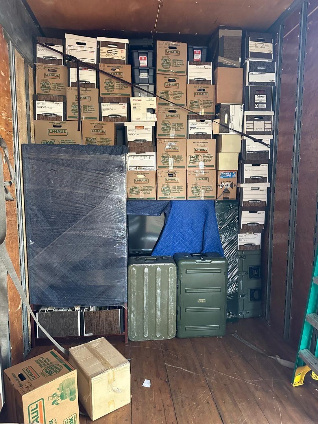 Full truck load of labeled boxes and padded furniture